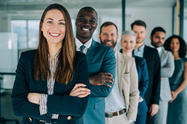 istock Confident businesswoman and her team. 1364657574