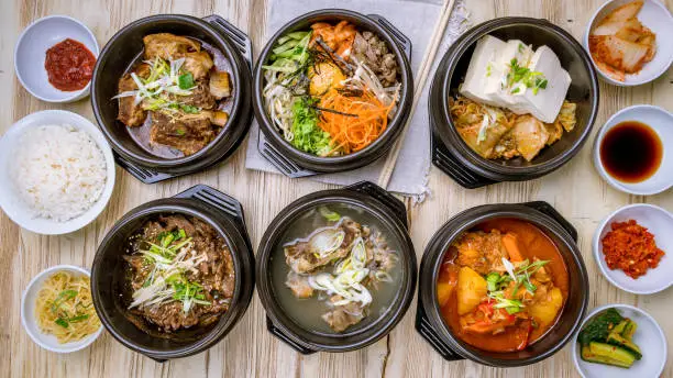 Photo of pibimbap, pork ribs, fried beef, tofu korean cuisine top view