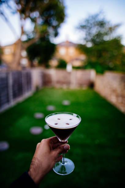 Man Holding Espresso Martini Man Holding Espresso Martini coffee liqueur stock pictures, royalty-free photos & images