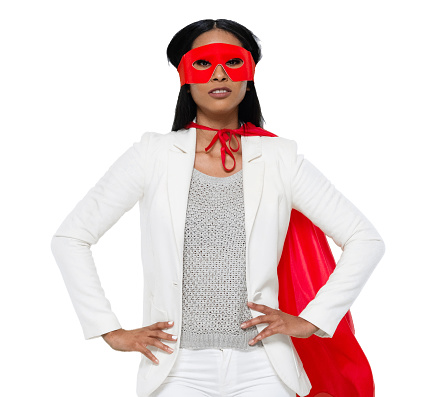 Front view of aged 20-29 years old who is beautiful with black hair latin american and hispanic ethnicity young women business person standing in front of white background wearing costume who is in concentration