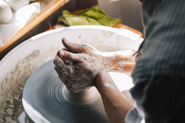 istock Anonymous Woman Potter Shaping Clay 1364660891