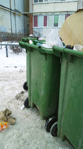 istock Trash container and rubbish near apartment building. Problem of cleanliness and garbage collection in city. Urban environment issues. Messy. Home or domestic household waste. Recycling rates. Vertical 1364661137