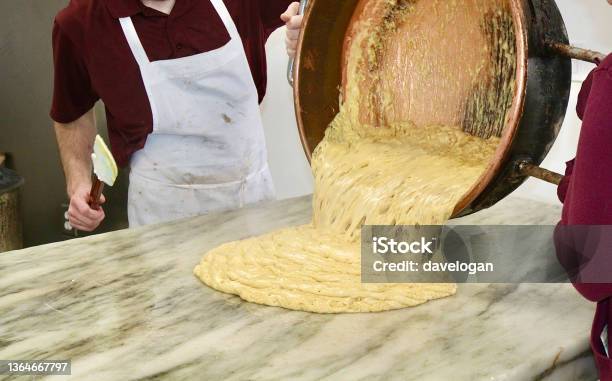 Pouring Out Fresh Peanut Brittle At A Candy Shop Stock Photo - Download Image Now - Mackinac Island, Bowl, Candy