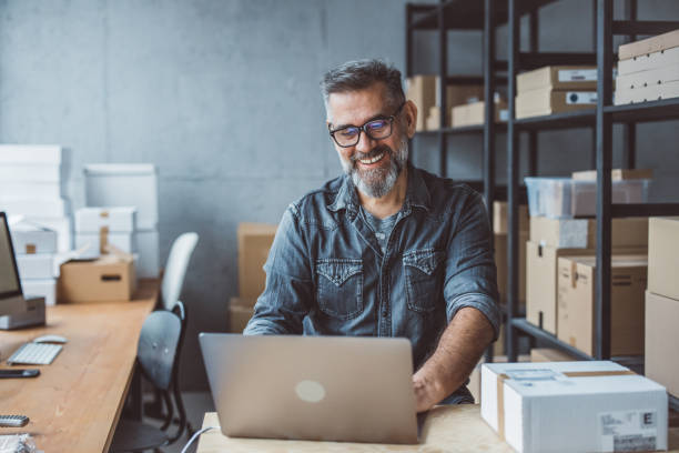 Small business owner Mature man working at warehouse for online seller business. warehouse office stock pictures, royalty-free photos & images