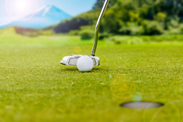 istock Golf course putting green and pure white golf ball 1364670541