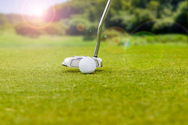 istock Golf course putting green and pure white golf ball 1364670687
