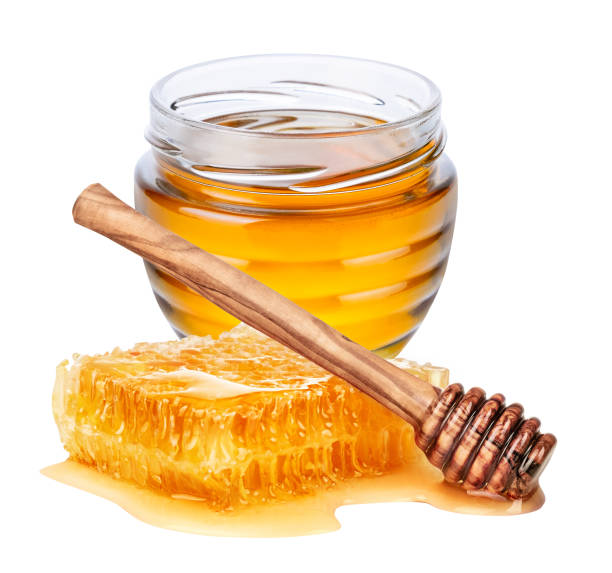 istock Jar with honey, honeycmb and honey dipper on white background 1364671324