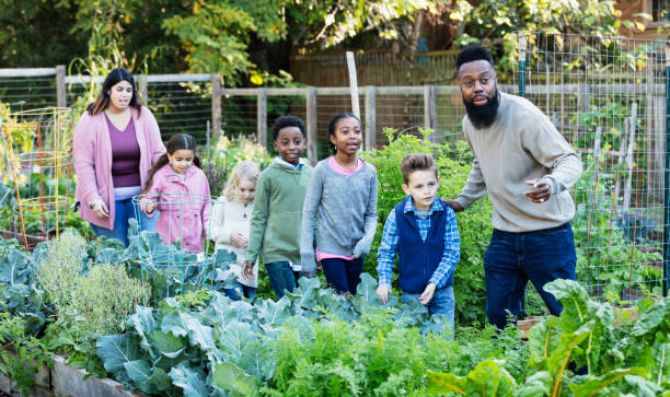 istock Children learning about plants at community garden 1364679698