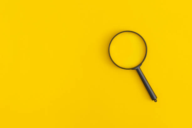 istock Magnifier on yellow backgroundMagnifier on yellow background 1364680289