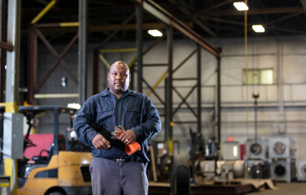 istock African-American man in warehouse holding work gloves 1364681895