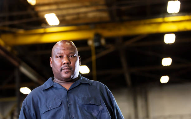 istock African-American man working in dark warehouse 1364681918