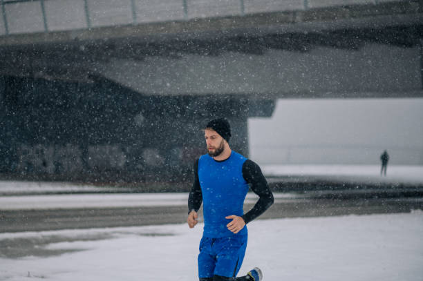 istock Man running outside on a cold winter day. 1364681936