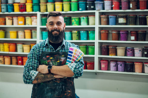 istock Male worker posing while mixing colors for screen printing in a workshop 1364681957