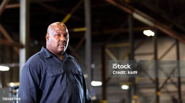 African-American man working in dark warehouse