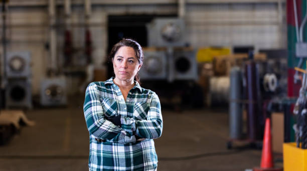 istock Mature woman standing in warehouse 1364682027