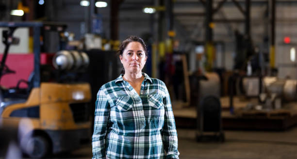 istock Mature woman standing in warehouse 1364682032