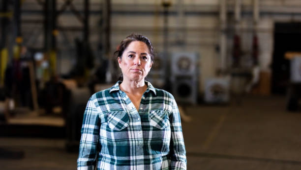 Mature woman standing in warehouse