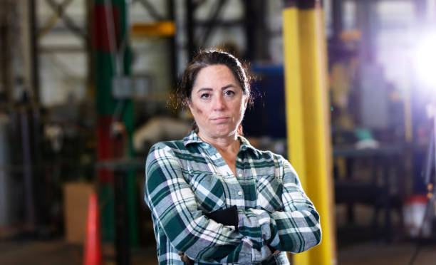 istock Mature woman standing in warehouse 1364682065