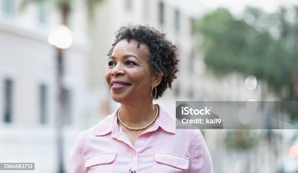 Headshot Of Mature Black Woman Walking On City Street Stock Photo - Download Image Now