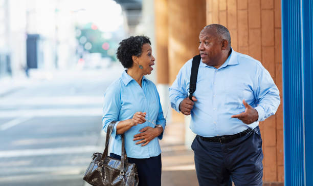 black business people walking, talking on city street - common serious couple men imagens e fotografias de stock