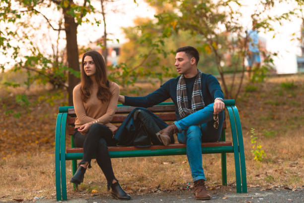 istock Angry girlfriend  ignoring her boyfriend while he is trying to apologize. 1364685469