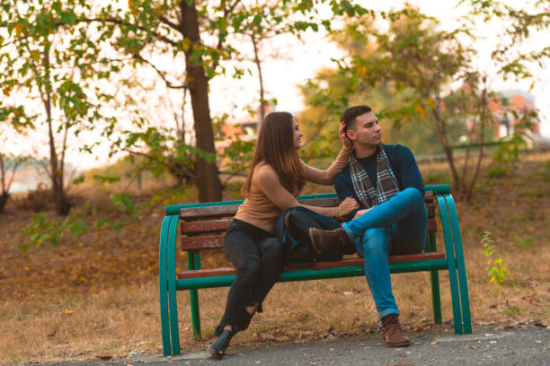 istock Angry boyfriend refusing to talk to his beautiful girlfriend while sitting in a park. 1364685470
