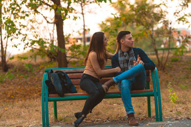 istock Angry boyfriend refusing to talk to his beautiful girlfriend while sitting in a park. 1364685471