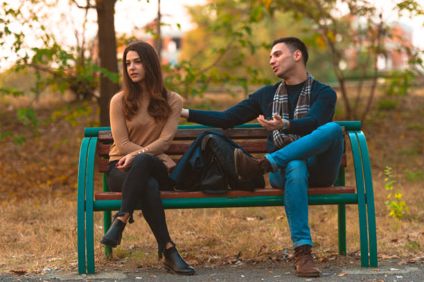 istock Angry girlfriend  ignoring her boyfriend while he is trying to apologize. 1364685480