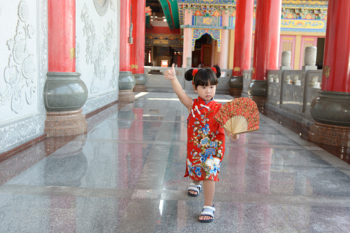 Little Asian girl in Chinese traditional dress to celebrate Chinese New Year.