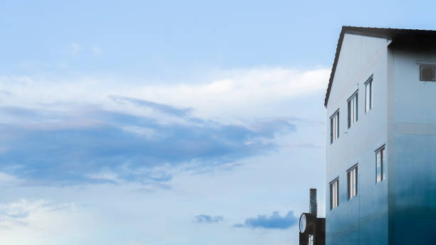 istock Window and Roof with Clouds in the Sky 1364695640