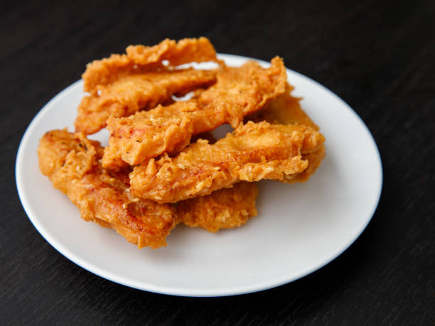 istock deep-fried fritters sliced banana, also known as Kluay khek, wooden table. 1364700721