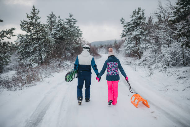 istock A young couple is having fun on a snowy mountain. View from behind 1364704618