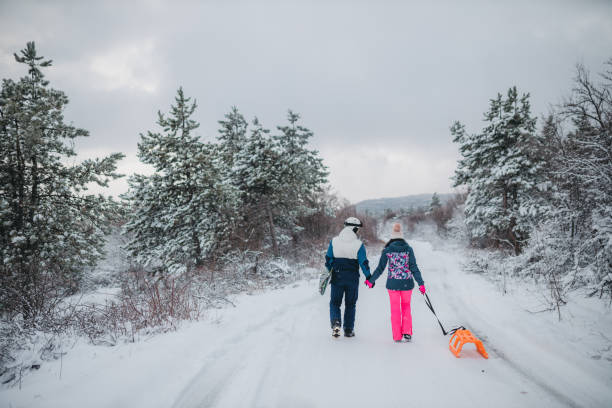 istock A young couple is having fun on a snowy mountain. View from behind 1364704619