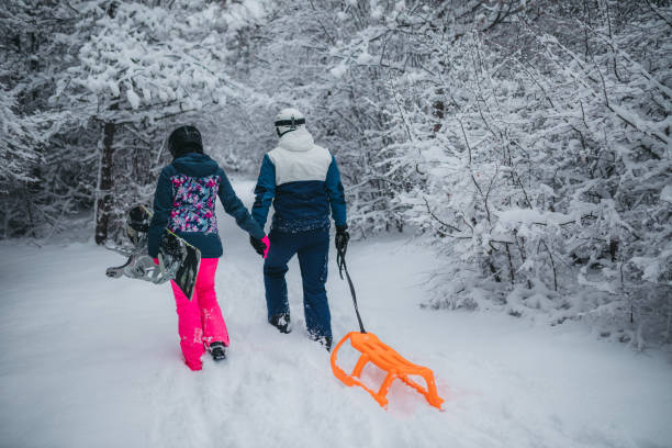 istock A young couple is having fun on a snowy mountain. View from behind 1364704627