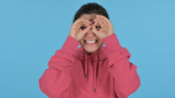 istock Indian Girl Looking Around, Searching, Blue Background 1364719862