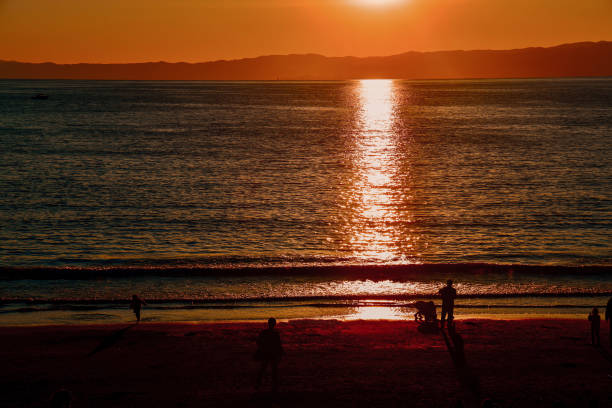 istock Silhouette mountins  on beach against alear sky during sunset 1364720889