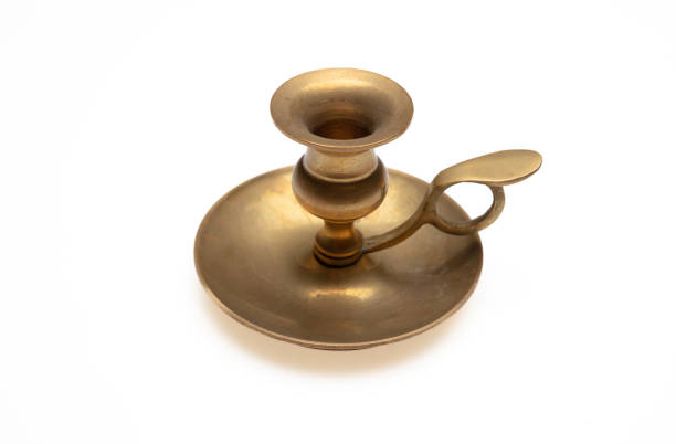 Vintage old bronze candlestick with burning candle. Retro style filtered photo