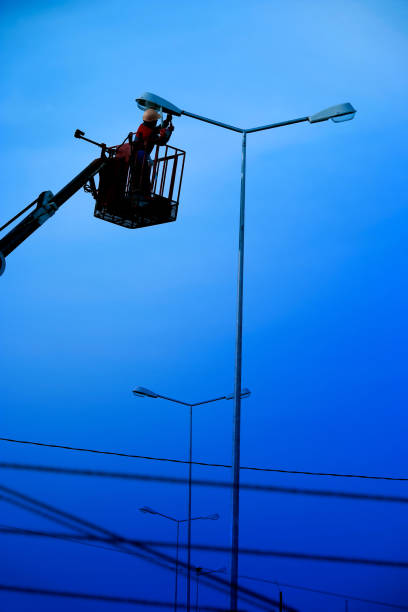 istock Technician works in a bucket high up on a street lights pole 1364722115