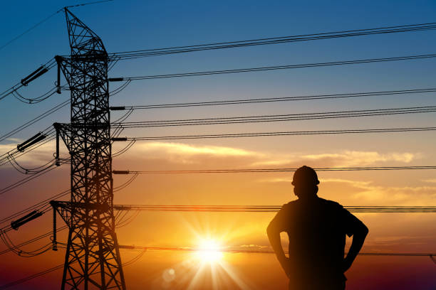 Electrician worker and electricity power lines over sunset sky Power line support,Technology maintenance and development industry concept muster station stock pictures, royalty-free photos & images