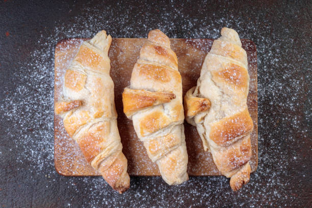 istock Top view of Homemade croissants on a brown desk. 1364724607