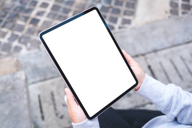 istock Top view mockup image of a woman holding digital tablet with blank white desktop screen 1364725606