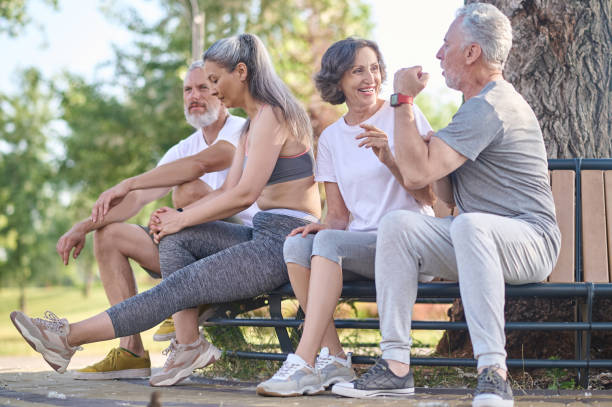 istock Mid aged people resting in the park after the workout 1364725694