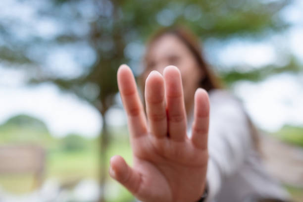 istock Blurred image of a woman outstretched hand and touching 1364725699