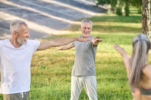 istock Group of mid aged people having a workout in the park 1364725747