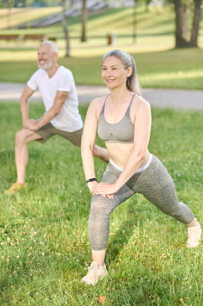 istock Group of people having a workout and doing lunges together 1364725766
