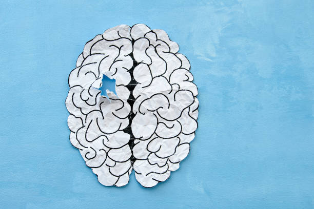 istock Paper brain damaged on a blue background. 1364726884
