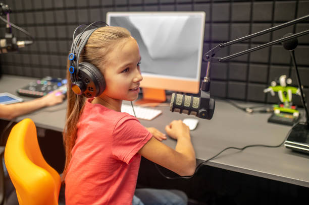 istock Young RJ talking into the microphone during the radio show 1364728600