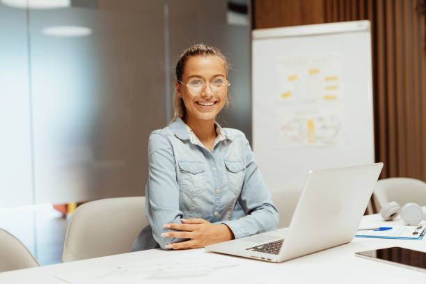 istock Smiling employee in office 1364729735