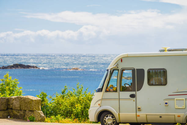 Camper car on coast of Norway with ocean view Tourism vacation and travel. Camper van and rocky coast landscape of southern Norway with an ocean view in Rogaland county Norway. stopover stock pictures, royalty-free photos & images