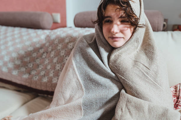 istock young woman is wrapped in warm blanket with her head 1364736418